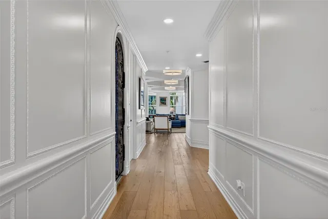 a living room with furniture a large window and a flat screen tv