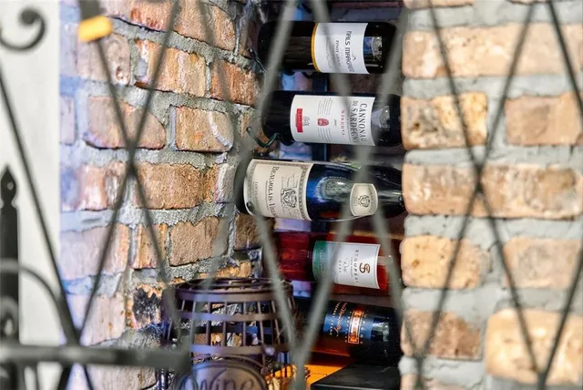 a living room with furniture kitchen view and a large window