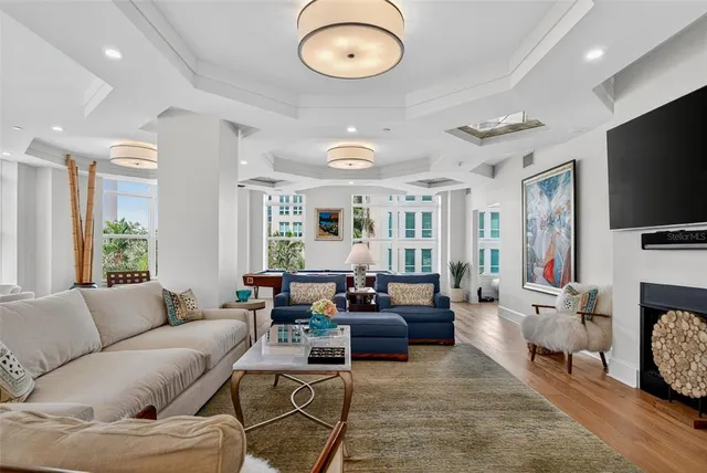 a living room with furniture flat screen tv and a fireplace