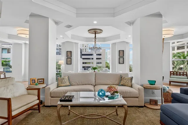 a view of a dining room with furniture wooden floor and chandelier
