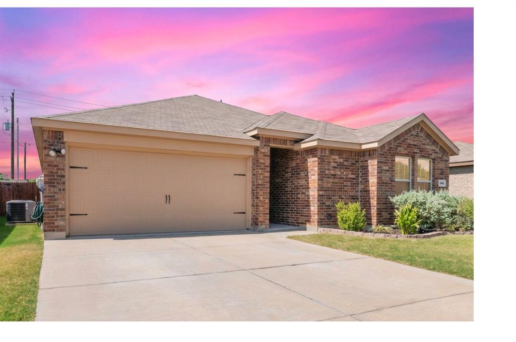 409 Wilson Way Denton, TX 76207 - Photo 5 of 33 Brick facade home featuring a two-car garage, concrete driveway, and front landscaping