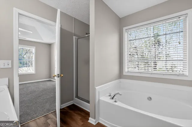 a bathroom with a bathtub and a shower