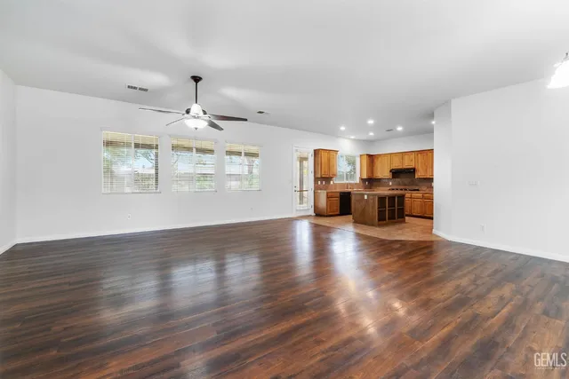 a view of a livingroom with furniture wooden floor windows and a chandelier