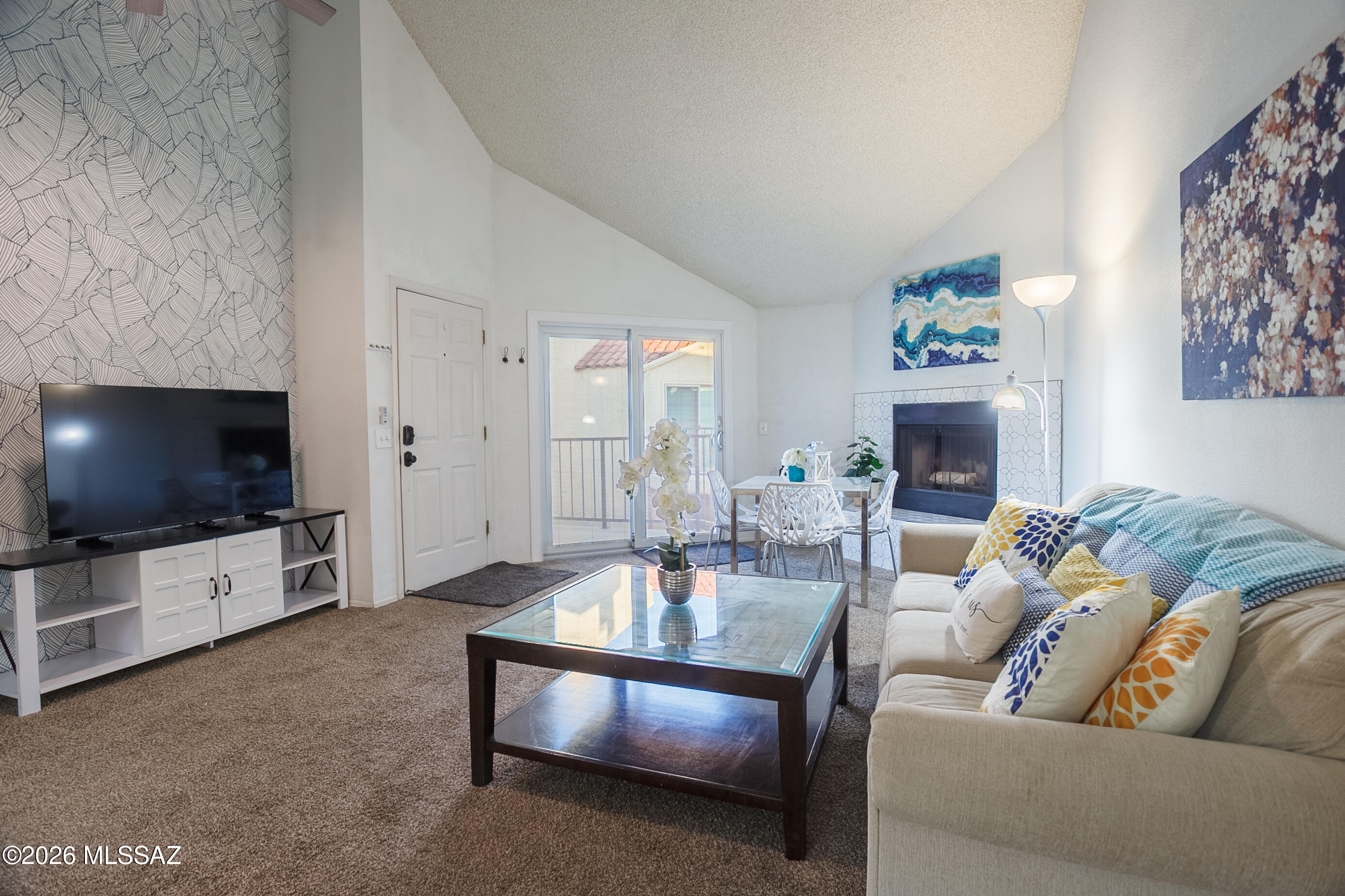 1200 East River Road, Unit B27 Tucson, AZ 85718 - Photo 5 of 40 a living room with furniture and a flat screen tv