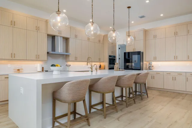 a view of a hallway with wooden floor and a bathroom