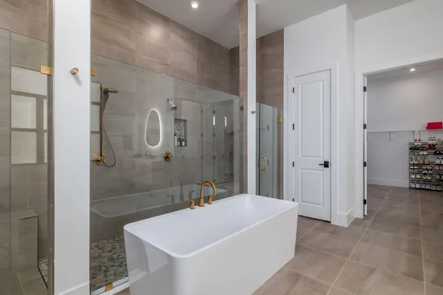 a spacious bedroom with a bed and a chandelier