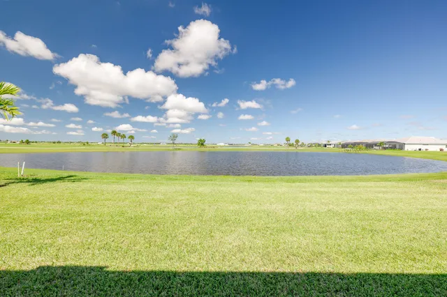 a large white kitchen with lots of counter space and refrigerator
