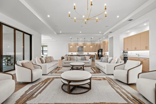 a kitchen with a dining table chairs sink and wooden floor