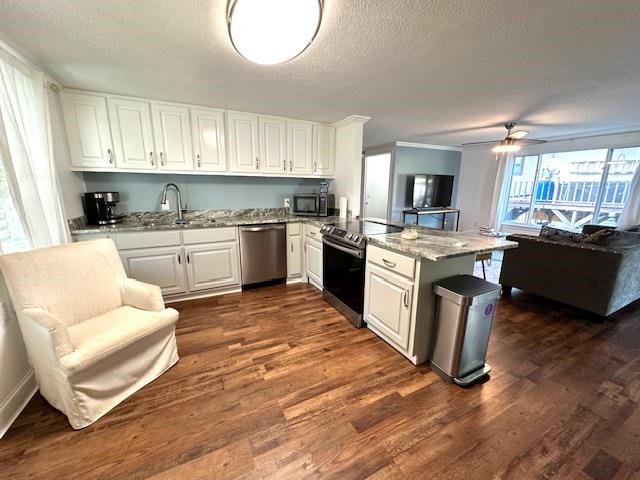 70 Point Way Saltillo, TN 38370 - Photo 14 of 36 Kitchen featuring appliances with stainless steel finishes, light stone countertops, dark wood-type flooring, white cabinets, and ceiling fan