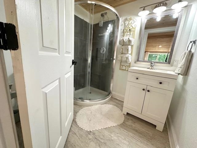 70 Point Way Saltillo, TN 38370 - Photo 19 of 36 Bathroom featuring wood-type flooring, walk in shower, and vanity