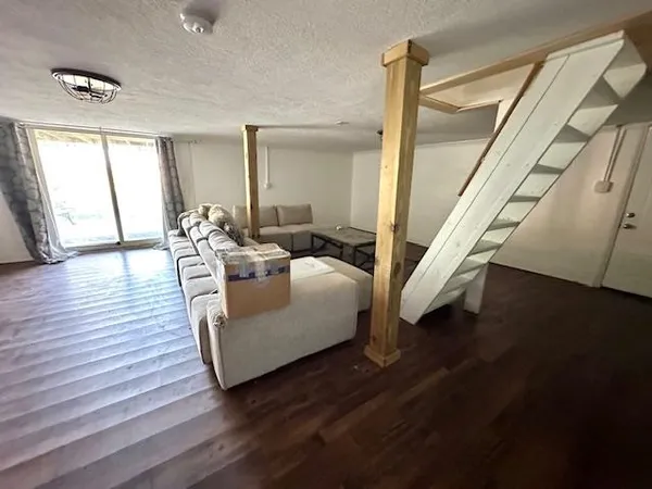 a living room with couches and a coffee table with wooden floor