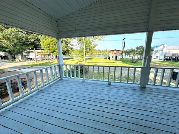 a view of a balcony with wooden floor