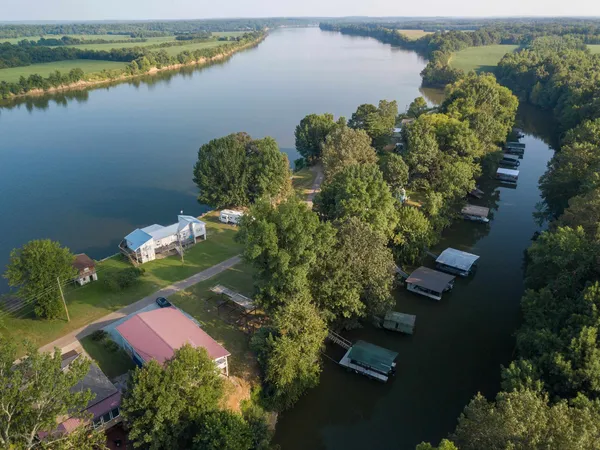 an aerial view of a house with a lake view