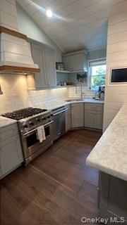 24 Woodridge Road Hampton Bays, NY 11946 - Photo 18 of 18 a kitchen with stainless steel appliances kitchen island granite countertop a stove a sink and a microwave