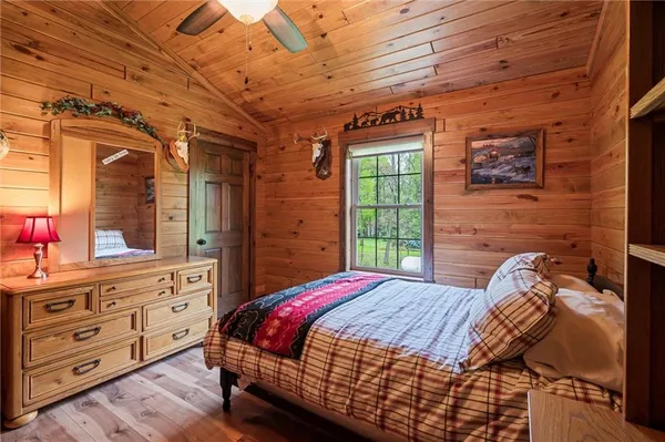 a bed sitting in a bedroom next to a window