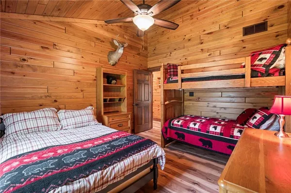 a bedroom with bed and a chandelier