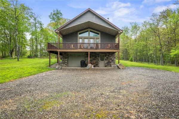 a view of a house with a yard and lawn chairs with plants
