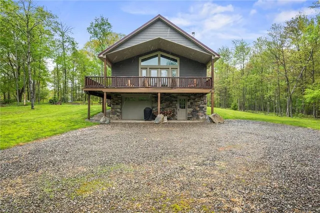 a view of a house with a yard and lawn chairs with plants