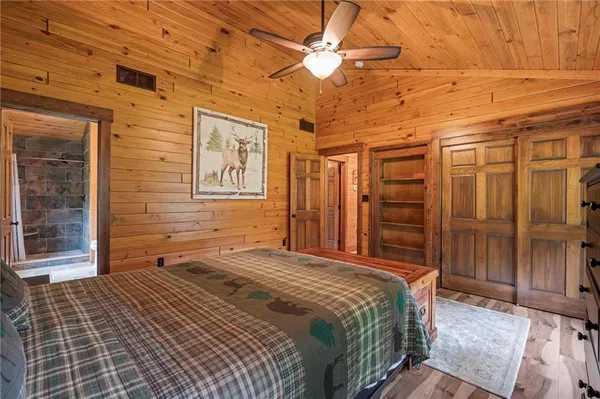 a bedroom with a bed dresser and a window