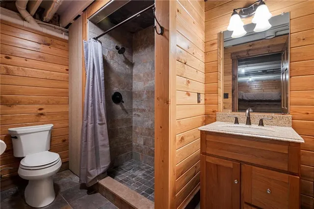 a bathroom with a toilet sink and shower