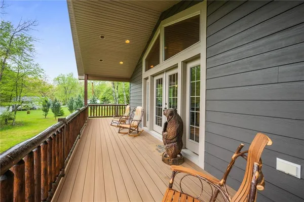 a view of a balcony with chairs and wooden floor