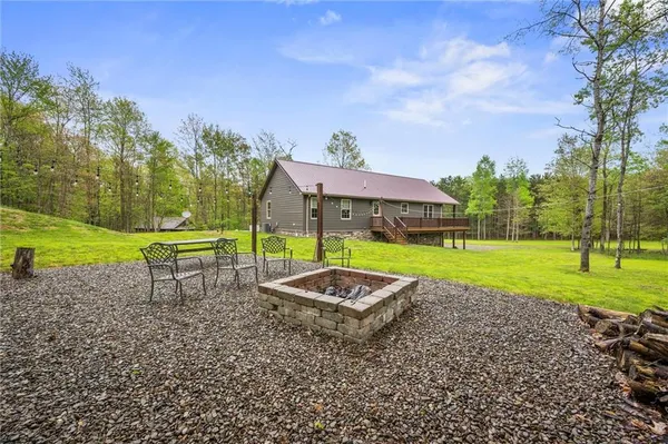 a view of a garden with a table and chairs