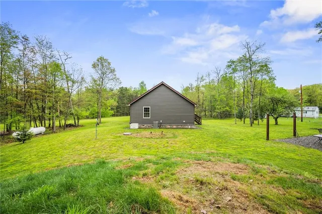 a house with huge green field in front of it