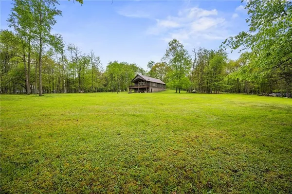 a view of a field with an trees in the background