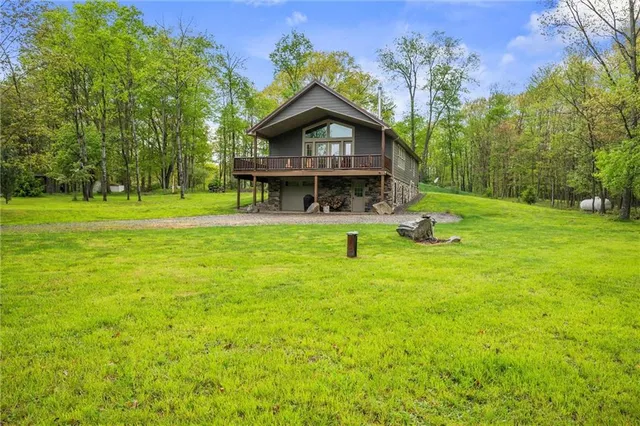 a front view of a house with a yard table and trees