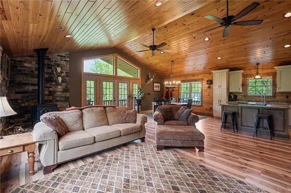 a living room with furniture a wooden floor and next to a window