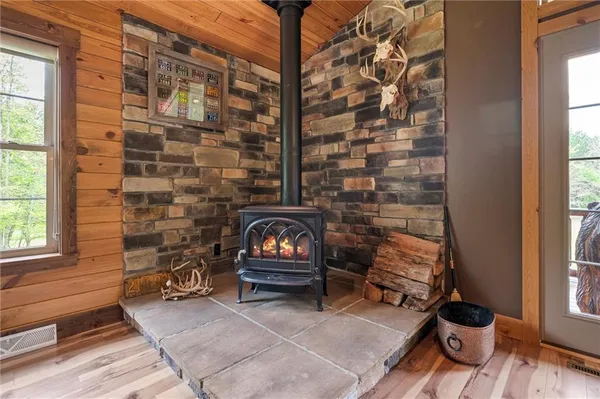 a living room with furniture a fireplace and a window