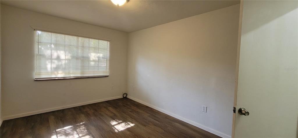 3120 Southwest 26th Terrace Gainesville, FL 32608 - Photo 25 of 25 an empty room with wooden floor and windows