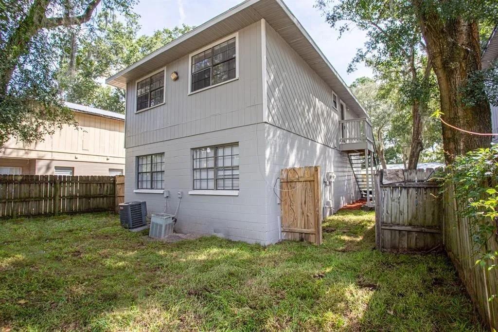 3120 Southwest 26th Terrace Gainesville, FL 32608 - Photo 4 of 25 a backyard of a house with barbeque oven and plants