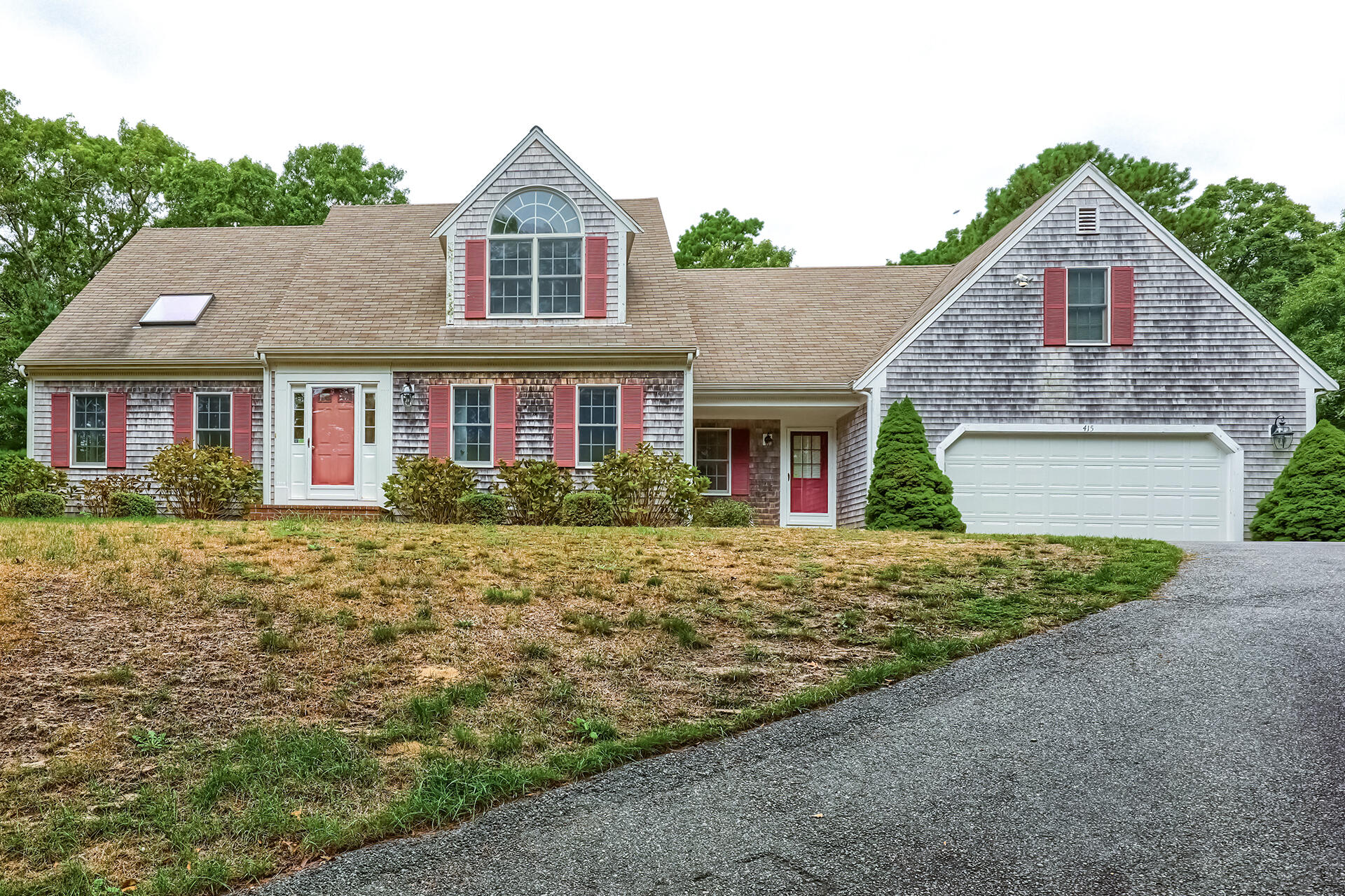 a front view of a house with a yard