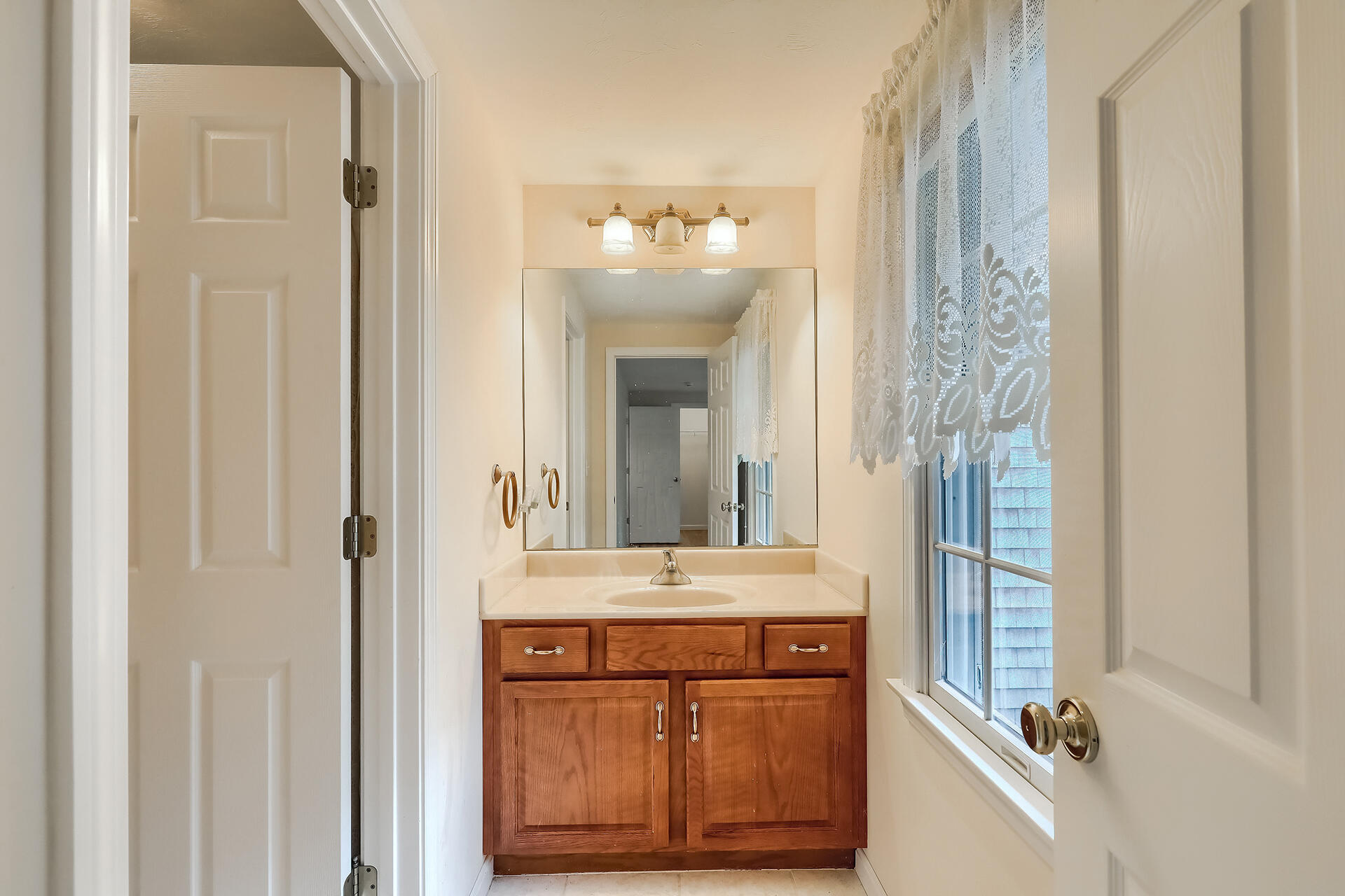 415 Shootflying Hill Road Centerville, MA 02632 - Photo 11 of 37 a bathroom with a mirror a sink and a shower