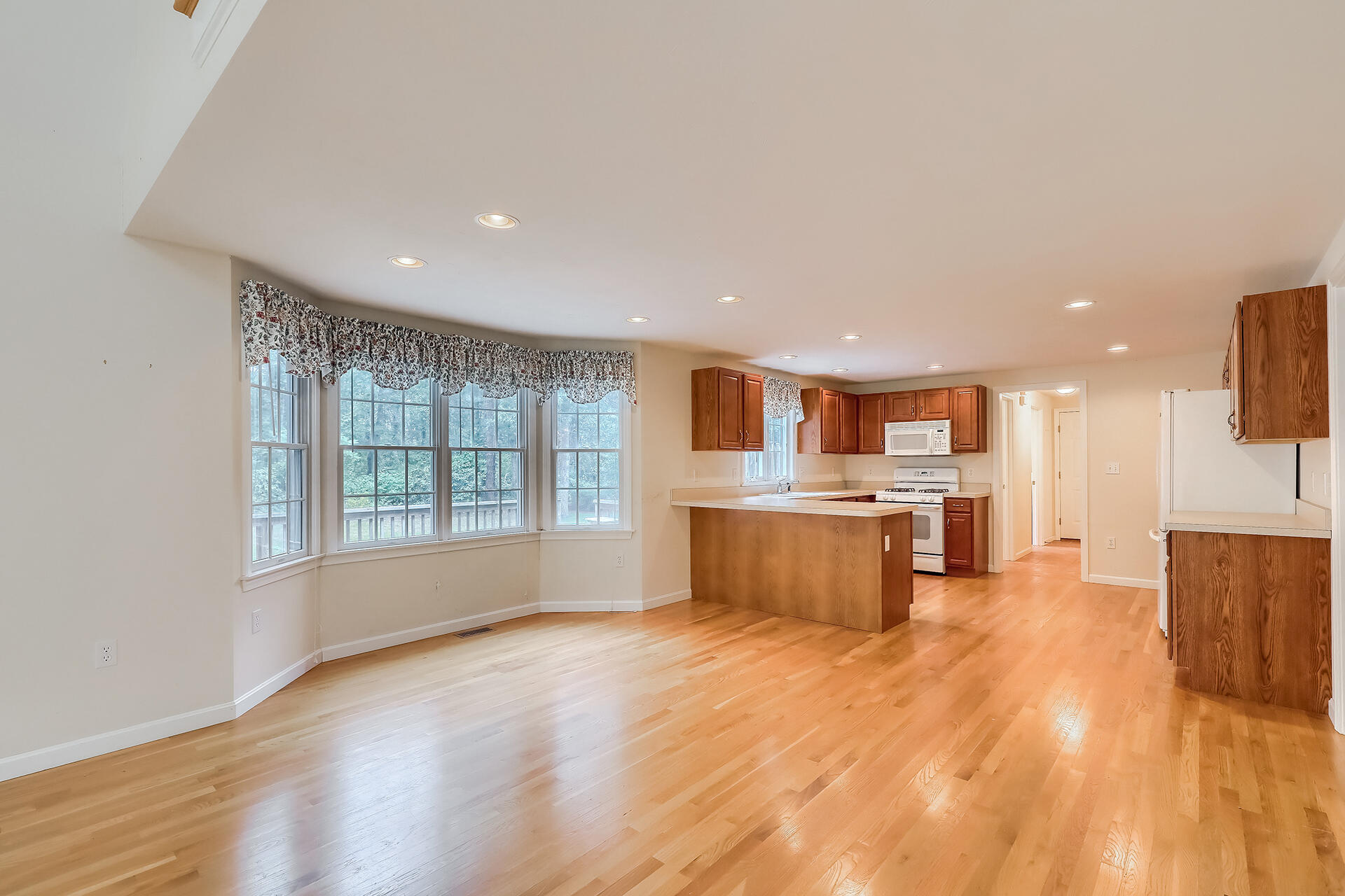 415 Shootflying Hill Road Centerville, MA 02632 - Photo 5 of 37 a large kitchen with stainless steel appliances granite countertop a large counter top a stove and a wooden floors