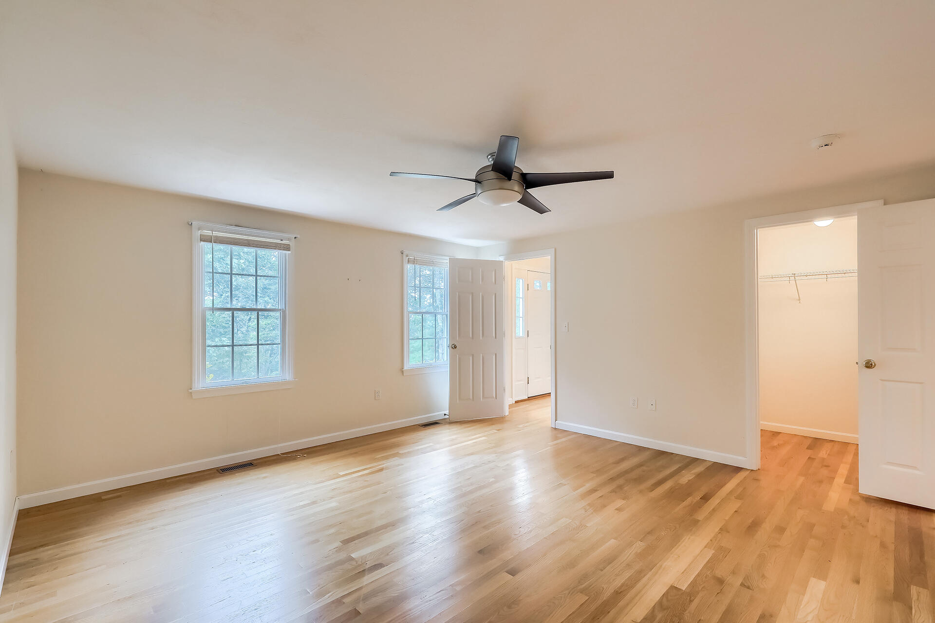 415 Shootflying Hill Road Centerville, MA 02632 - Photo 8 of 37 a view of an empty room with wooden floor and a window