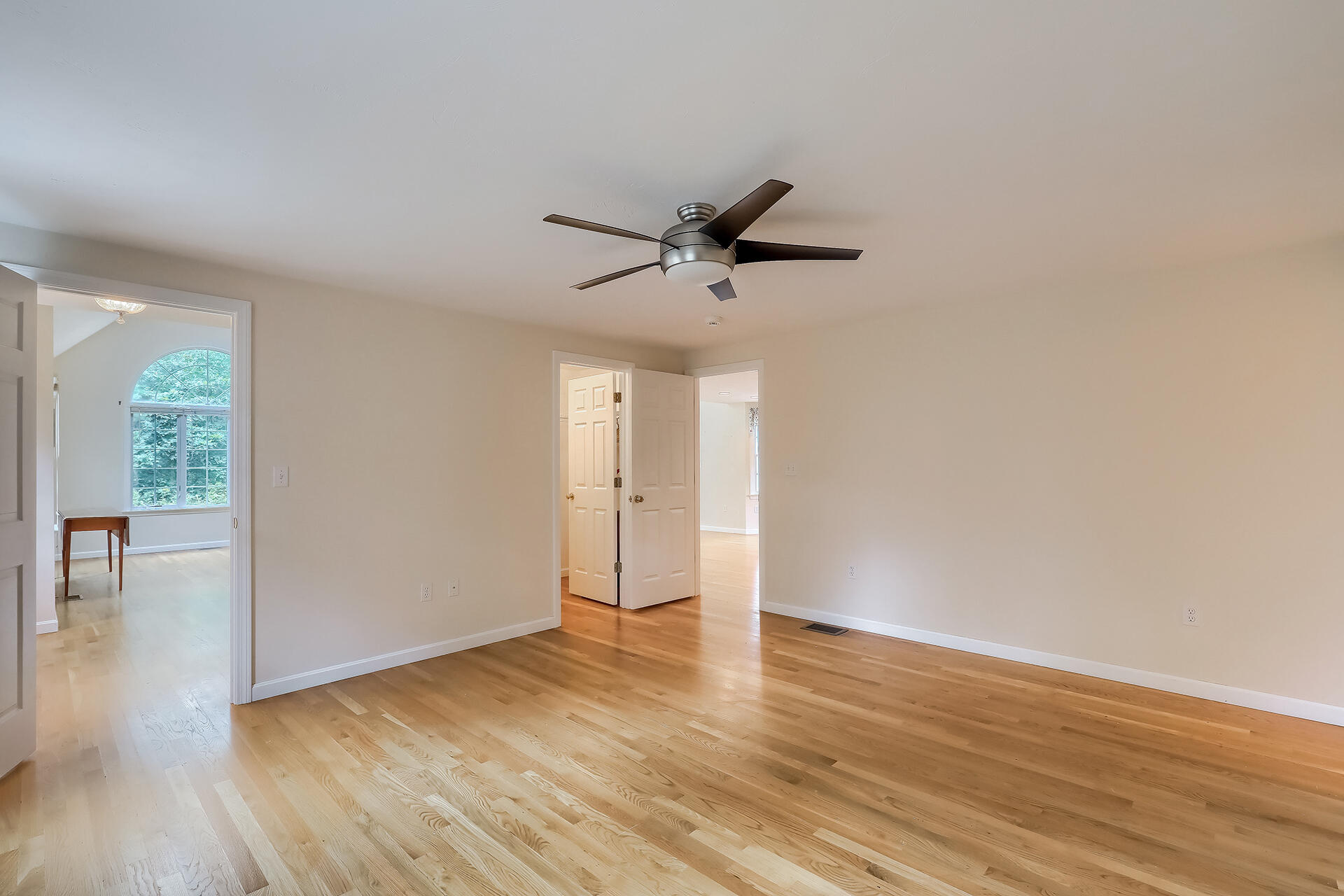 415 Shootflying Hill Road Centerville, MA 02632 - Photo 9 of 37 a view of an empty room with wooden floor and a window