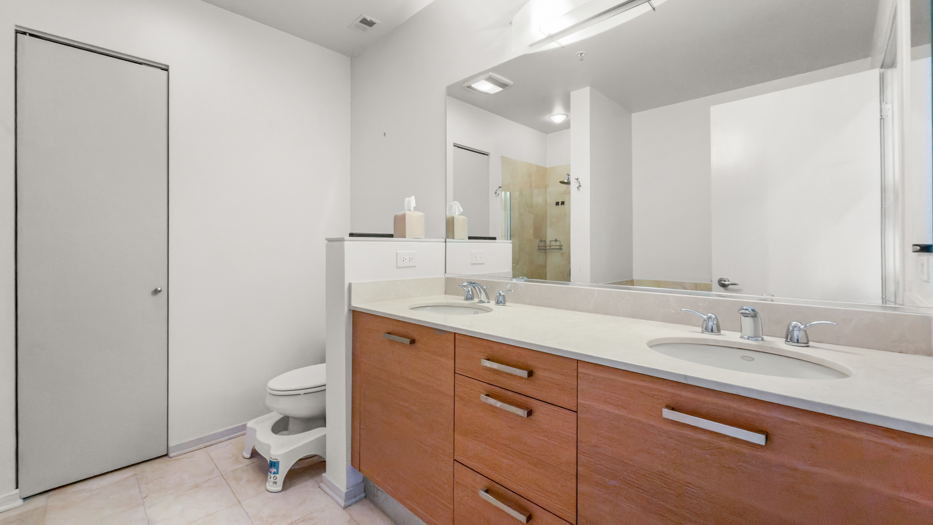 500 West Superior Street, Unit 2002 Chicago, IL 60654 - Photo 13 of 27 a bathroom with a granite countertop sink a toilet and a mirror