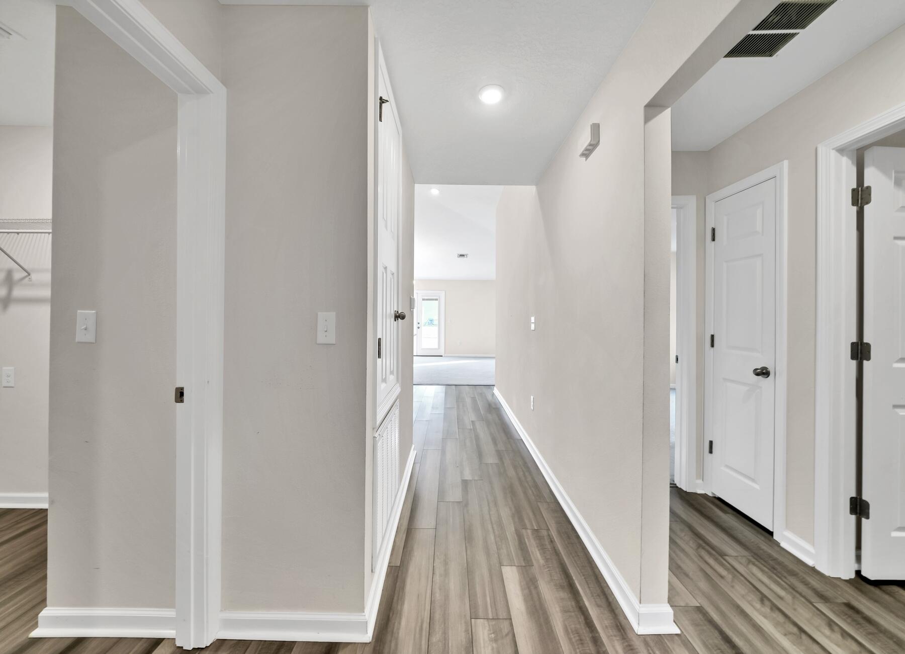 10 Riverwalk Crossing Freeport, FL 32439 - Photo 12 of 35 a view of a hallway with wooden floor and a bathroom