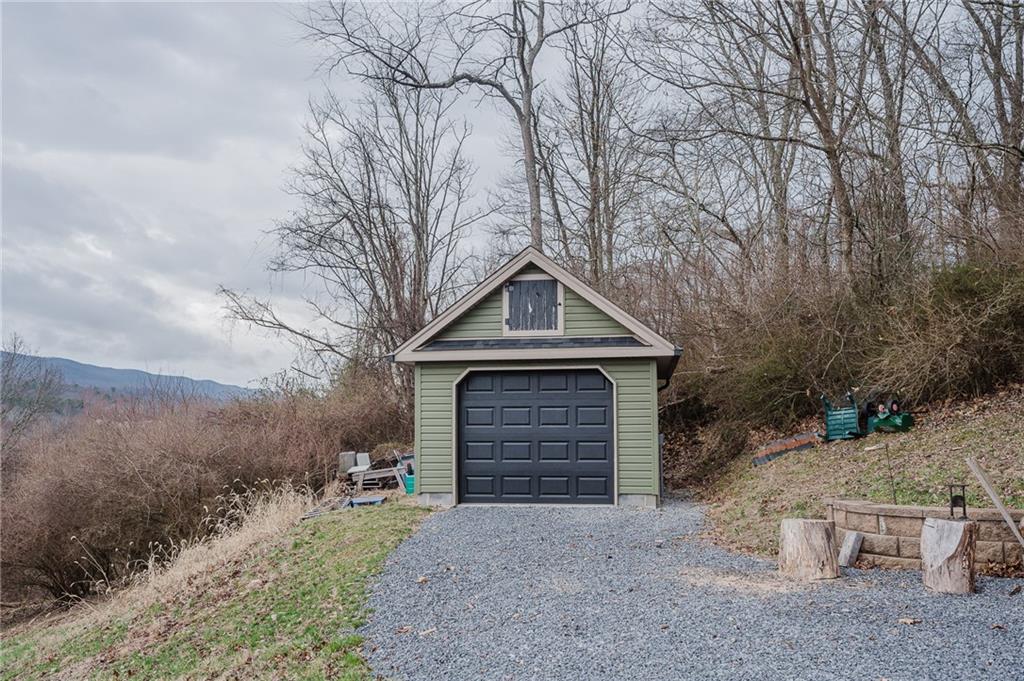 143 Chimney Ridge Road Bedford, PA 15522 - Photo 13 of 50 a front view of a house with yard and garage