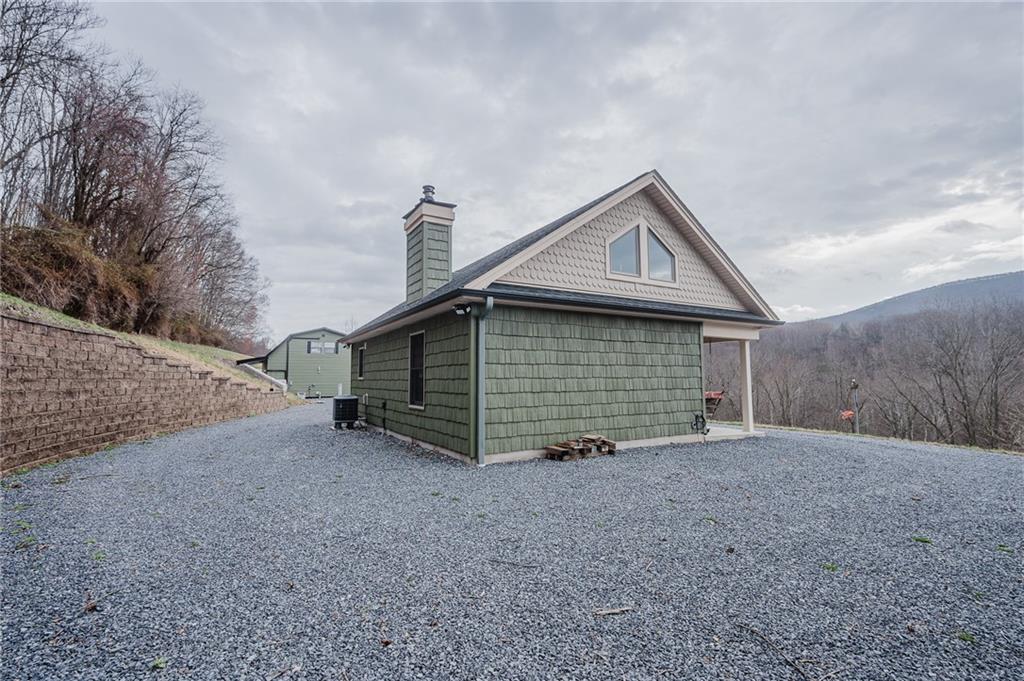 143 Chimney Ridge Road Bedford, PA 15522 - Photo 14 of 50 a front view of a house with a yard and garage