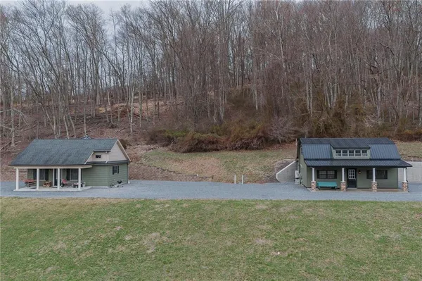 a front view of a house with a garden