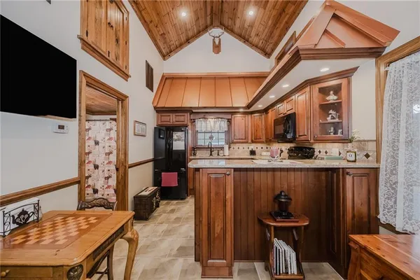 a living room with a table chairs and a flat screen tv