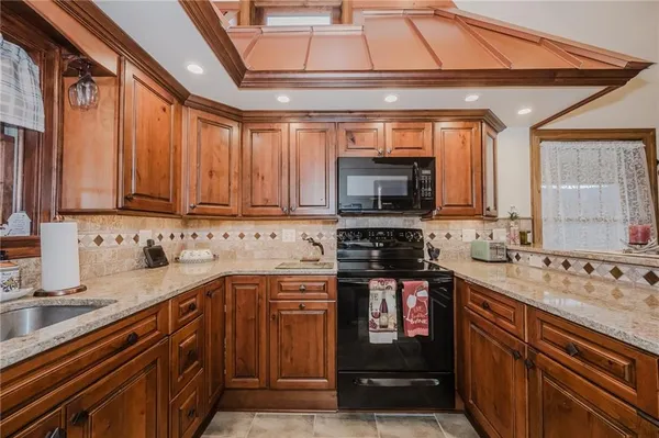 a kitchen with stainless steel appliances a stove sink microwave and cabinets