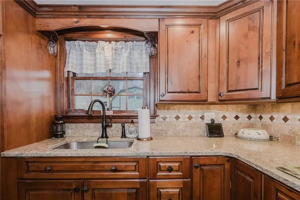 a sink with granite countertop a sink and cabinets