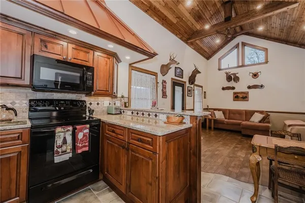 a kitchen with stainless steel appliances granite countertop a stove and a microwave