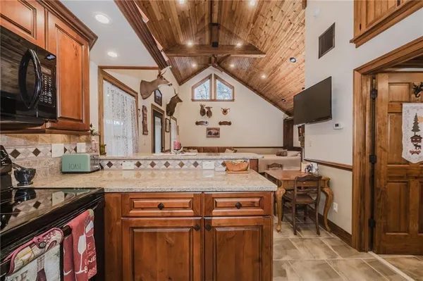 a bathroom with a granite countertop toilet sink and shower curtain