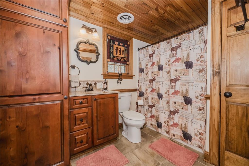 143 Chimney Ridge Road Bedford, PA 15522 - Photo 31 of 50 a bathroom with a granite countertop toilet sink and shower curtain