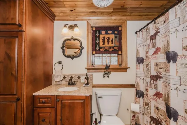 a view of a room with wooden walls and glass door